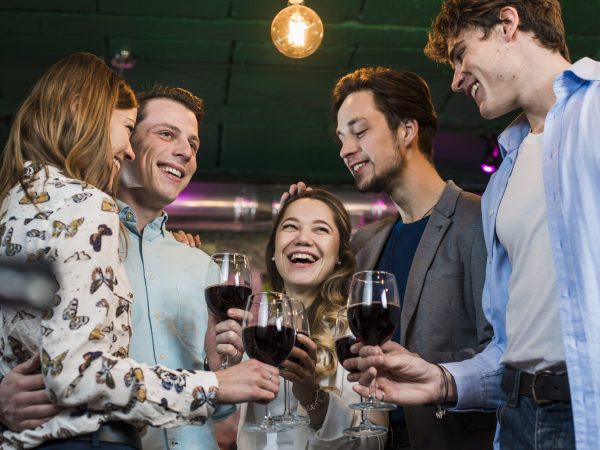 group-happy-friends-enjoying-evening-drinks-bar
